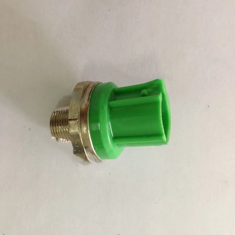 Green car knock sensor with metal and plastic construction for engine knock detection
