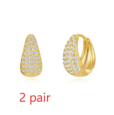 Gold tone brass diamond earclip earrings with geometric round shape and European styling
