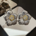 Retro copper stud earrings with textured gardenia floral design and two-tone electroplated finish