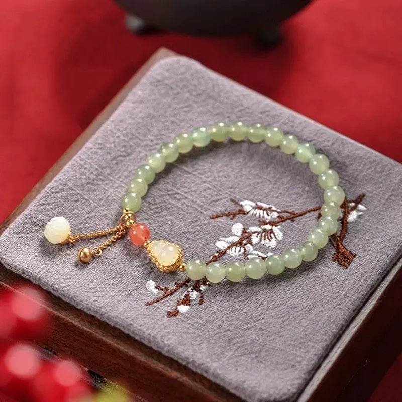 Qingshui jade bracelet with gold plated gourd charm and fu character pendant on adjustable cord