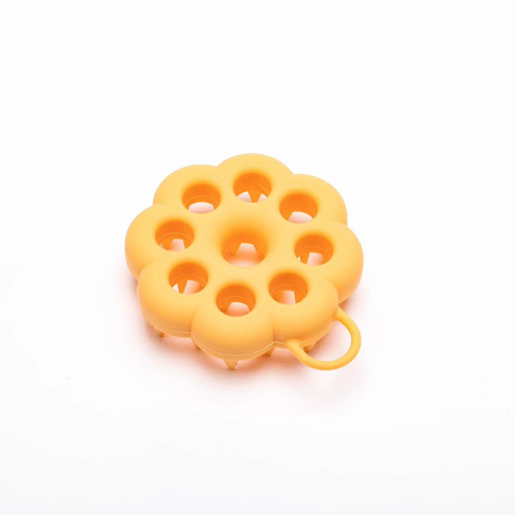 Blue silicone pet grooming brush with flexible massage bristles for wet or dry use on cats and dogs.