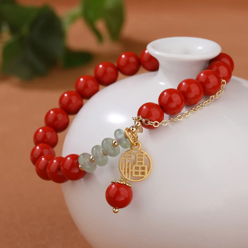 Retro red sand cinnabar bracelet with fu character charm, jade ornament, and 8mm tassel