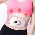 Pink rechargeable menstrual cramp relief belt with fabric wrap and button control, placed on a light background