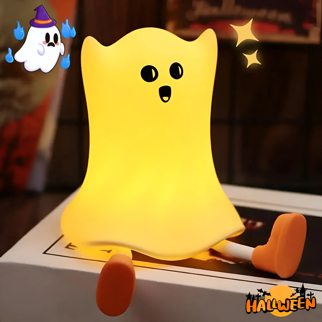 Cartoon ghost-shaped silicone bedside lamp with touch control, soft yellow glow on a bedside table
