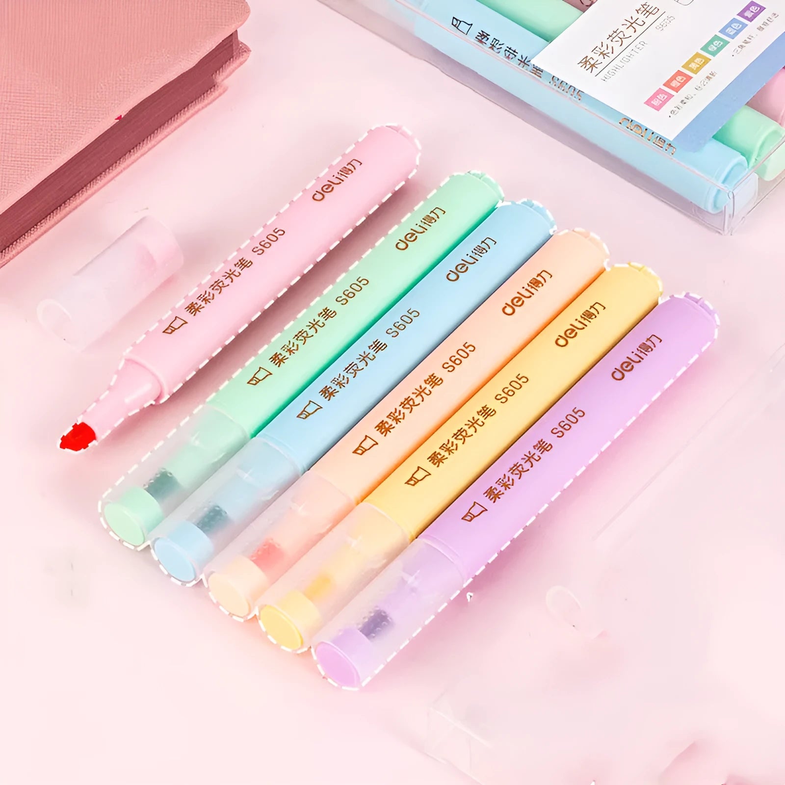 Deli S605 highlighter pens with oblique fibre tips in macaron colours on a notebook