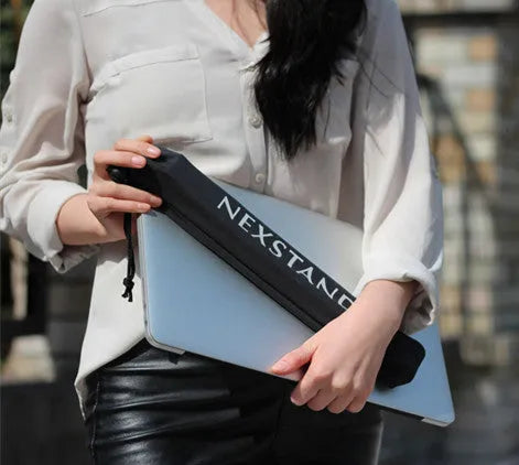 Black folding portable laptop stand made from reinforced nylon, shown folded to its compact size.