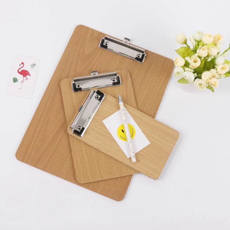 A4 wooden clipboard with metal clip and hanging hole placed on a desk