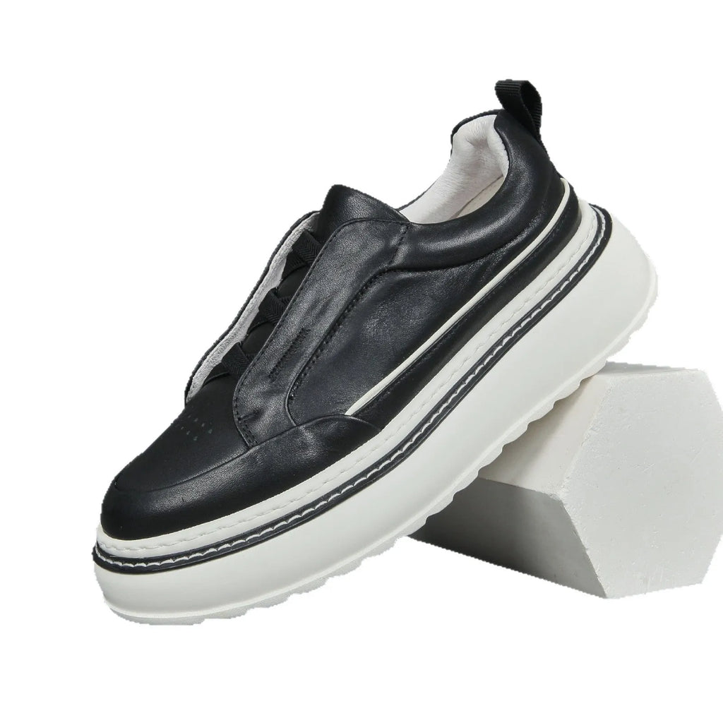 Breathable casual slip-on sneaker in black with first layer cowhide upper, platform mid heel, and sewing thread detail