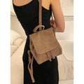 Retro suede girls backpack in brown with shoulder strap and sewing thread detailing