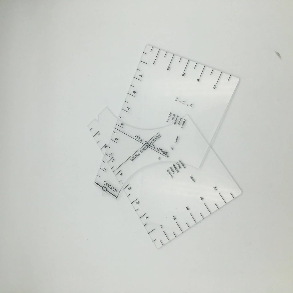 Transparent acrylic sewing ruler template for T-shirt patch alignment showing etched measurement markings
