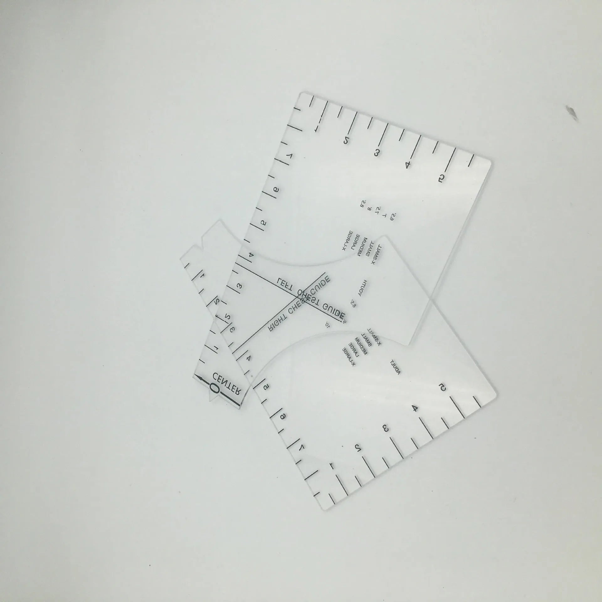 Transparent acrylic sewing ruler template for T-shirt patch alignment showing etched measurement markings