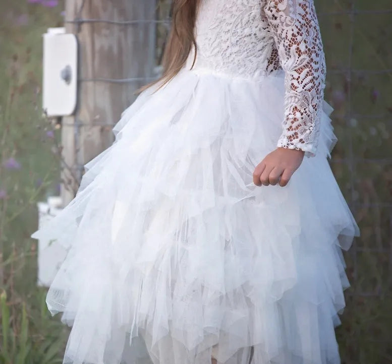 White long-sleeved lace princess dress for girls with an irregular hemline, shown on a hanger.