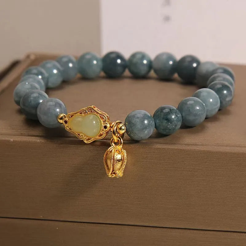 Natural stone bracelet with blue beads, lotus pendant, and adjustable leather strap
