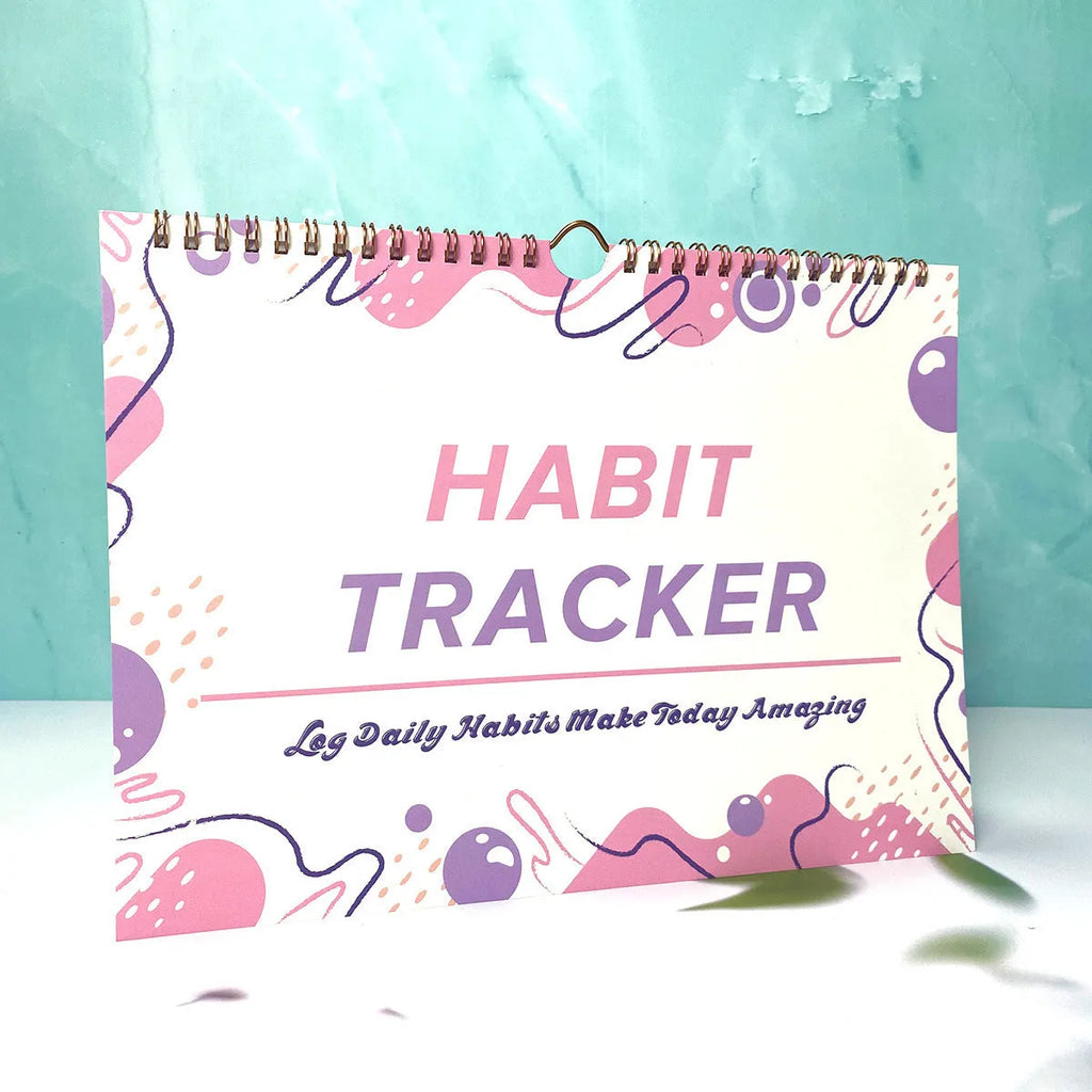 A4 habit tracking book with coloured cover open to show interior pages