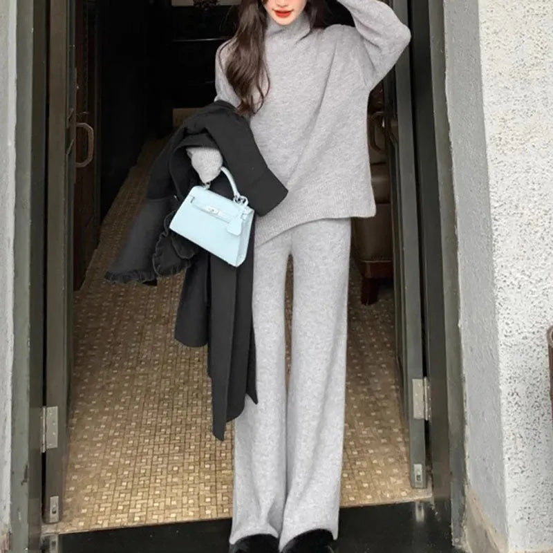 Women's beige acrylic fibre sweater and wide-leg trousers two-piece set on a hanger.