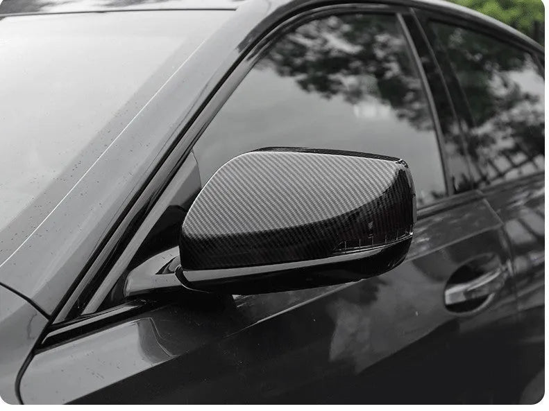 Pair of ABS plastic rearview mirror covers for Cadillac CT5 and CT6 cars in carbon fibre pattern finish.