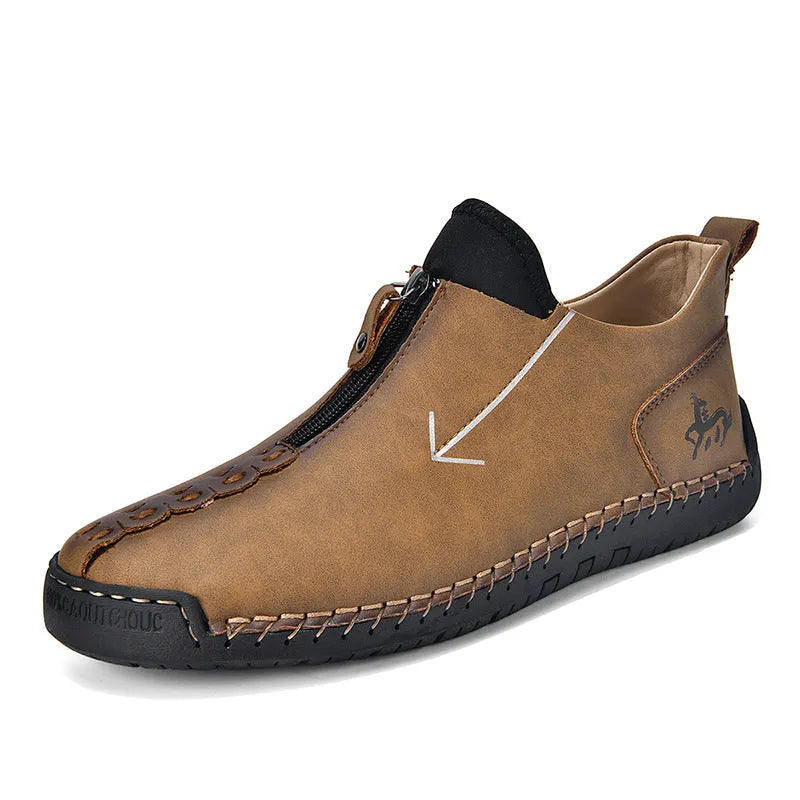 Men's brown zip-up Martin boots with round toe and hand-stitched rubber sole on a neutral background.