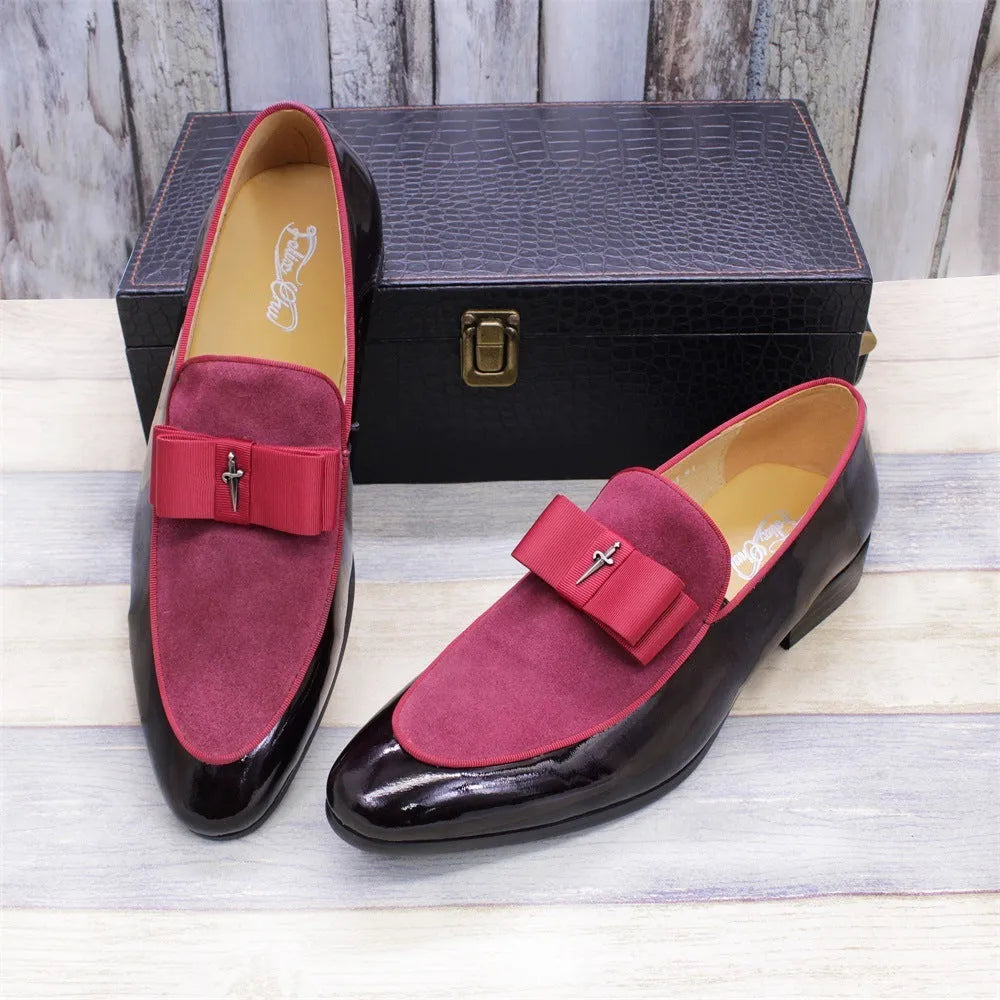 Men's black patent leather shoes with a gold tassel detail on a rubber sole.