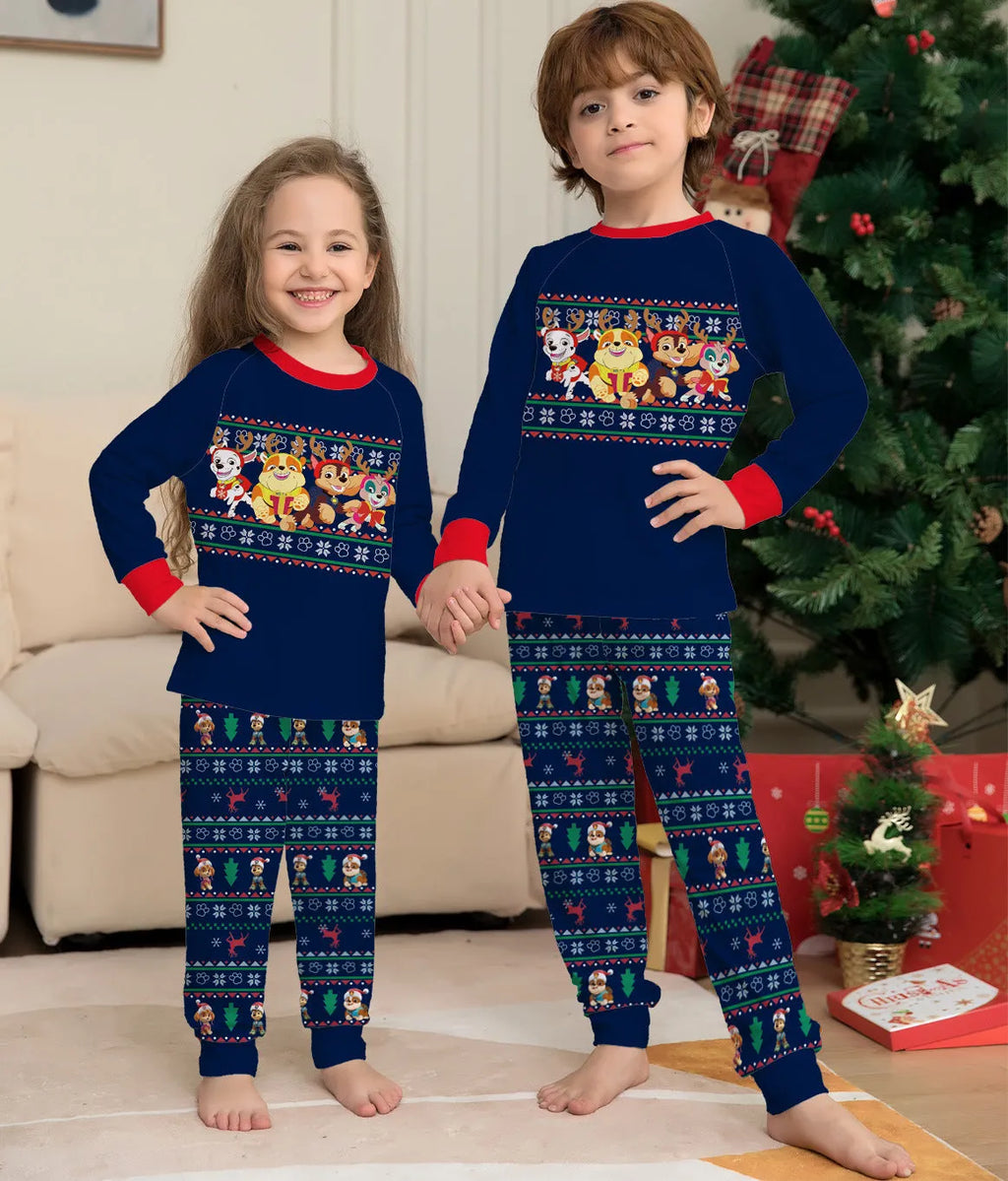 Matching family wearing red plaid Christmas deer print cotton pyjamas, including adults, children, and a dog.