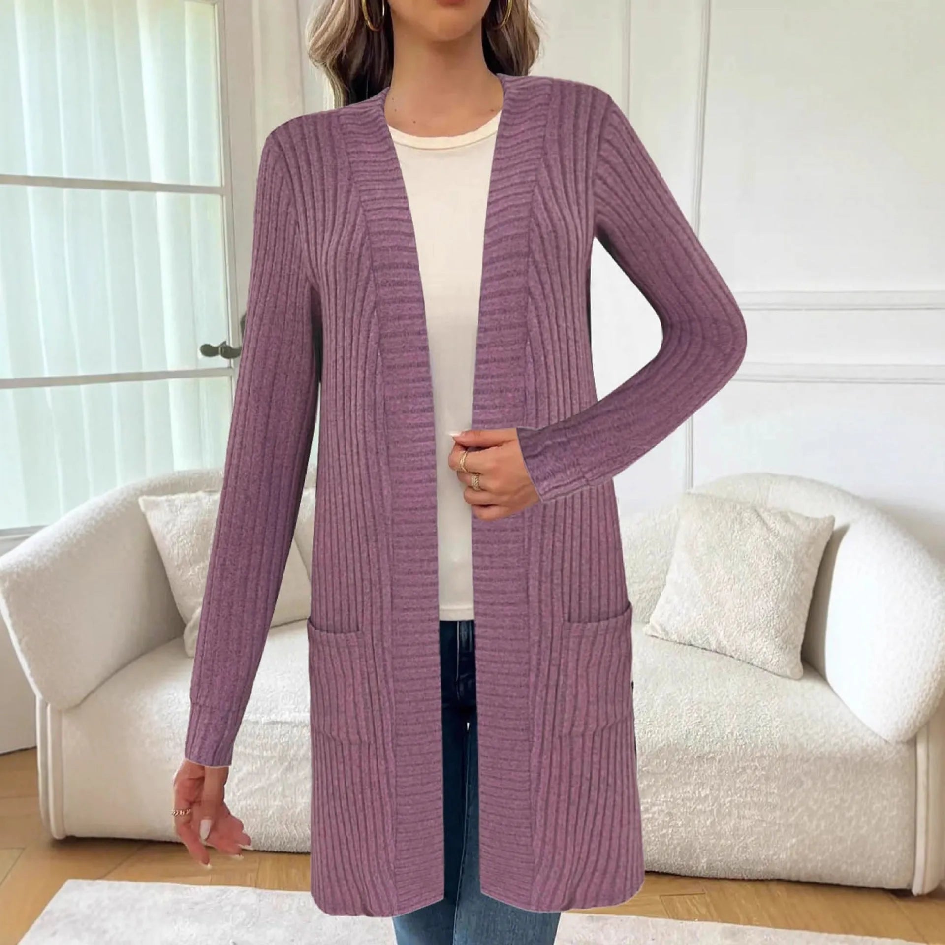 A woman wearing a loose-fit long sleeve knitted cardigan jacket with pockets, available in black, grey, or wine red.