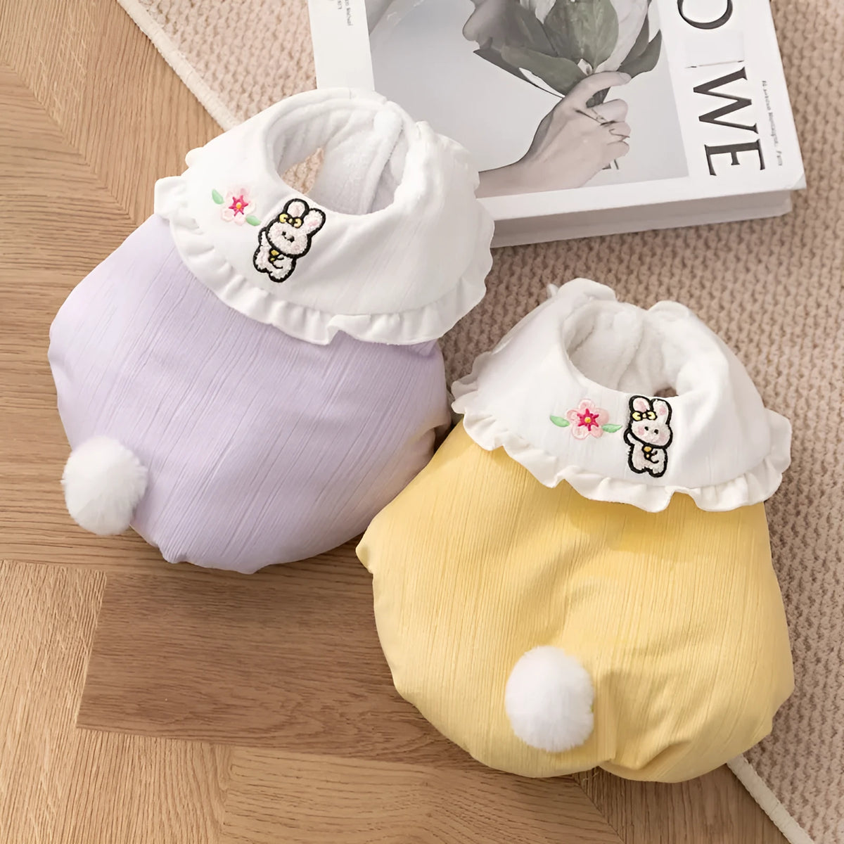Bunny embroidered pet coat with ruffled white collar and fluffy pom-pom tail in lavender colour on a small dog