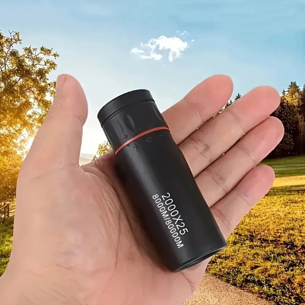 Black monocular telescope with mobile phone holder attached for outdoor observation