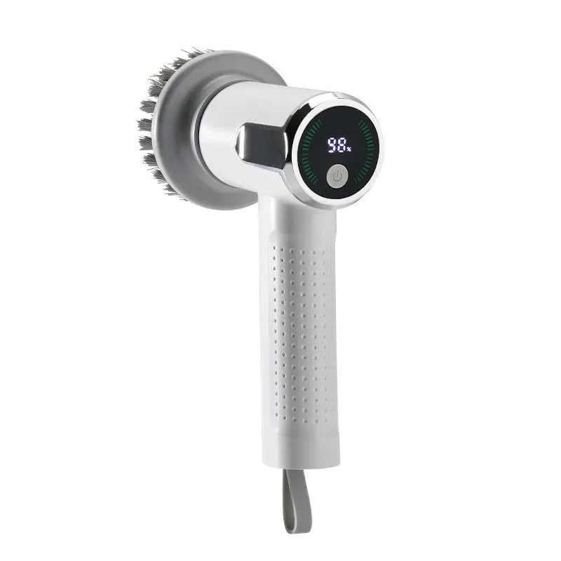 White wireless electric cleaning brush with replaceable head on a kitchen counter