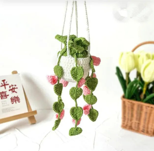 Green and white knitted wool car plant decoration with 8cm base and hanging rope.