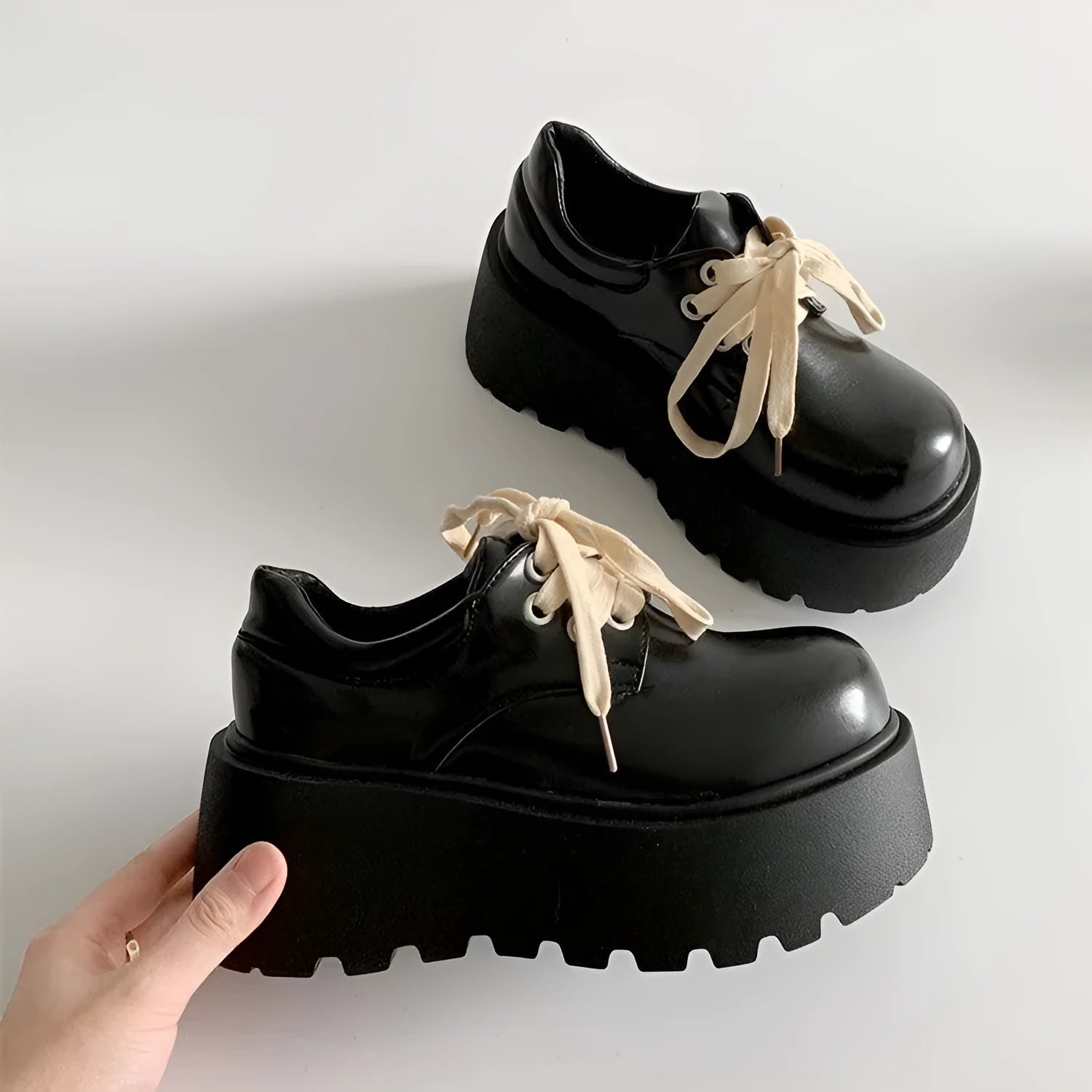 Matte black women's lace-up leather shoes with a thick sole and a chunky heel.