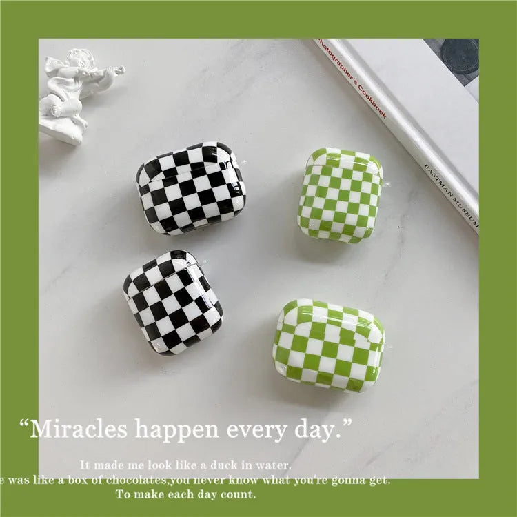 Black and green checkerboard pattern TPU protective case for Apple AirPods, shown with an optional attached lanyard.