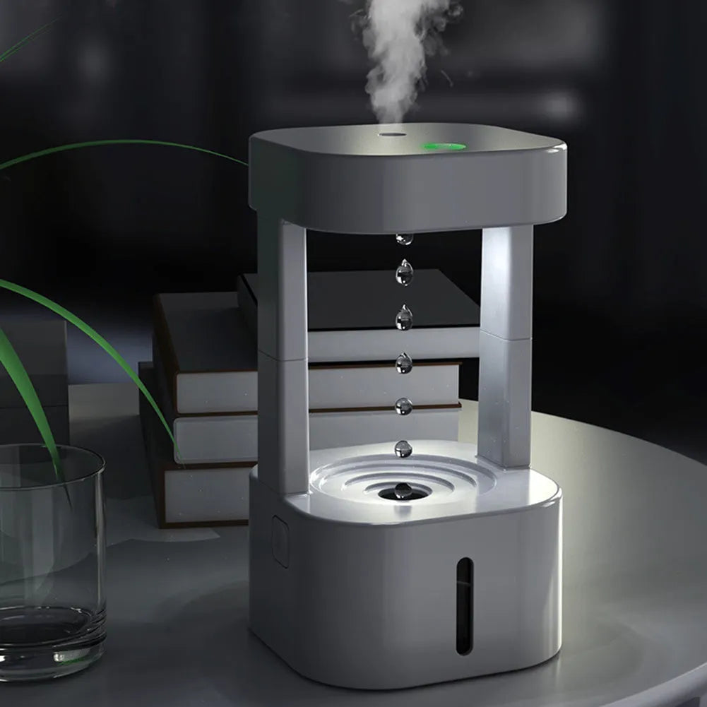 White anti-gravity water droplet USB humidifier with coloured lights on a desk