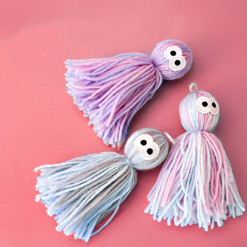 Blue and grey bite-resistant wool ball cat toy hanging from a teaser stick.
