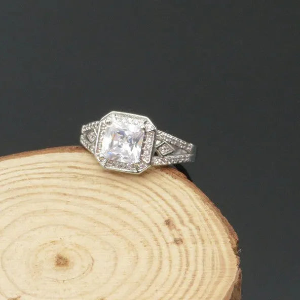Women's geometric ring with hollow design and inlaid zircon stone in platinum colour.