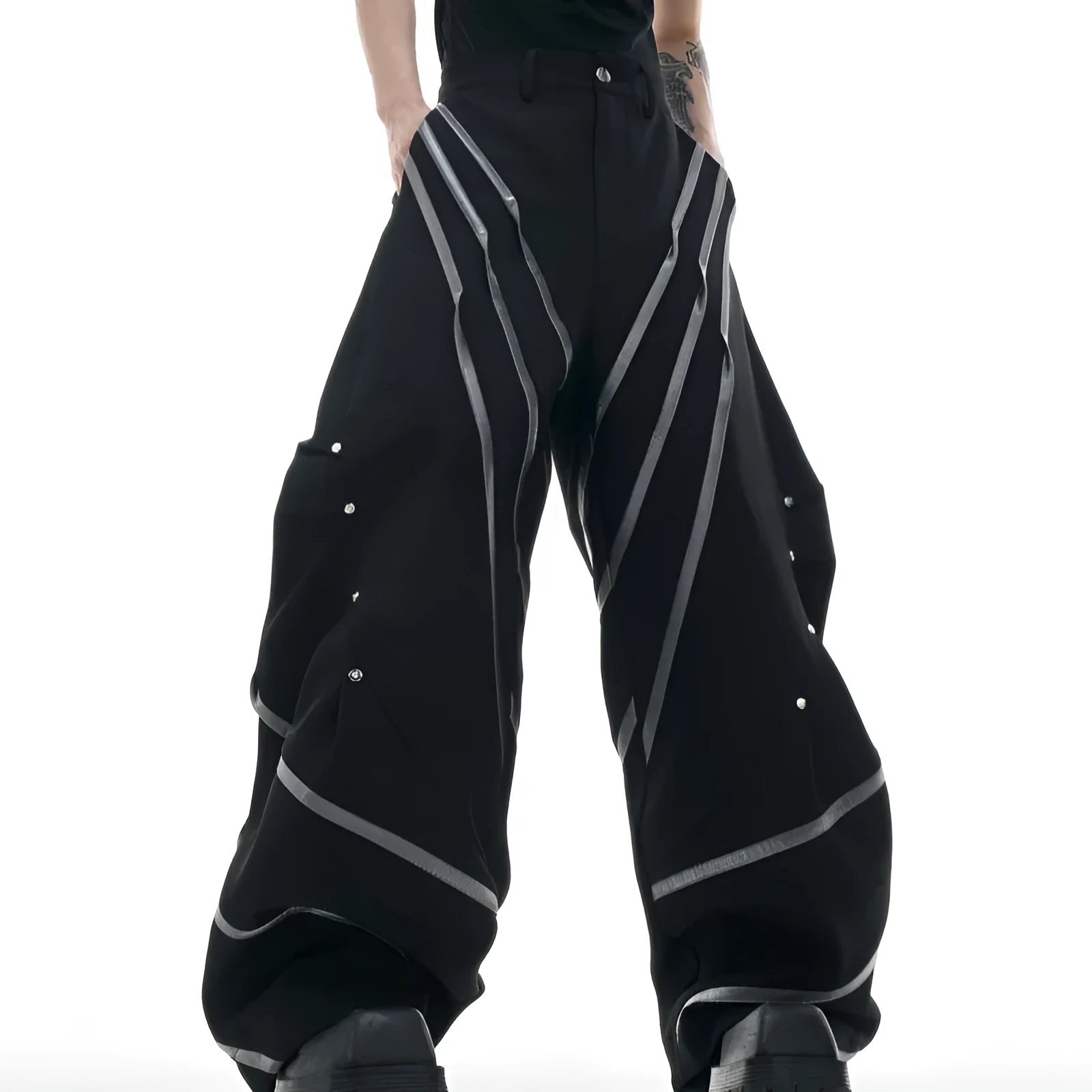 Men's black polyester trousers with metal striped rivet pleats and three-dimensional tailoring.