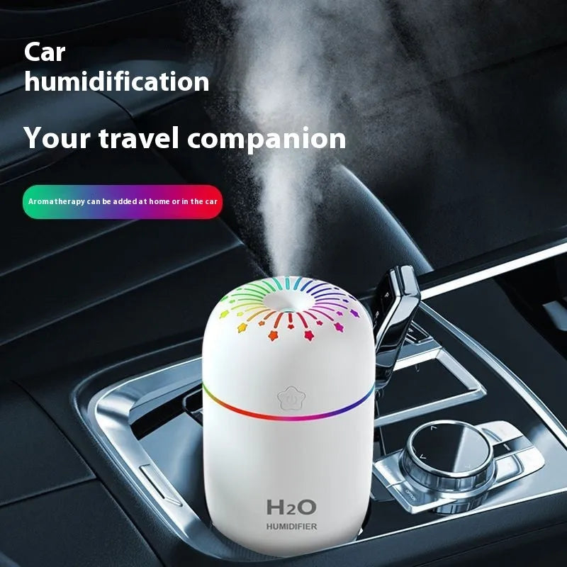 Small white USB portable humidifier with fireworks design on a wooden desk