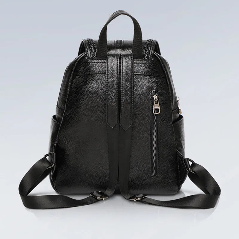 Solid colour genuine leather women's backpack showing blue and wine red options with internal compartments.