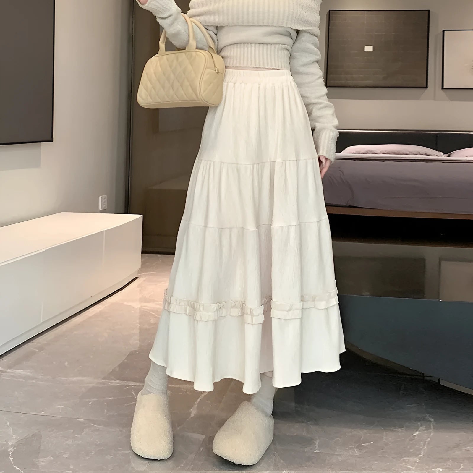 Korean style beige corduroy A-line midi skirt with elastic waistband on a hanger.