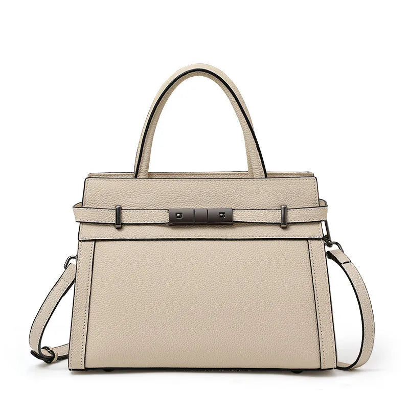 A structured square genuine leather women's crossbody bag in black, shown open to reveal internal organiser pockets.