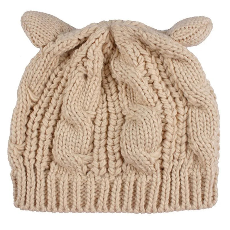Handmade knitted winter beanie with 3D cat ears in red, shown on a model.