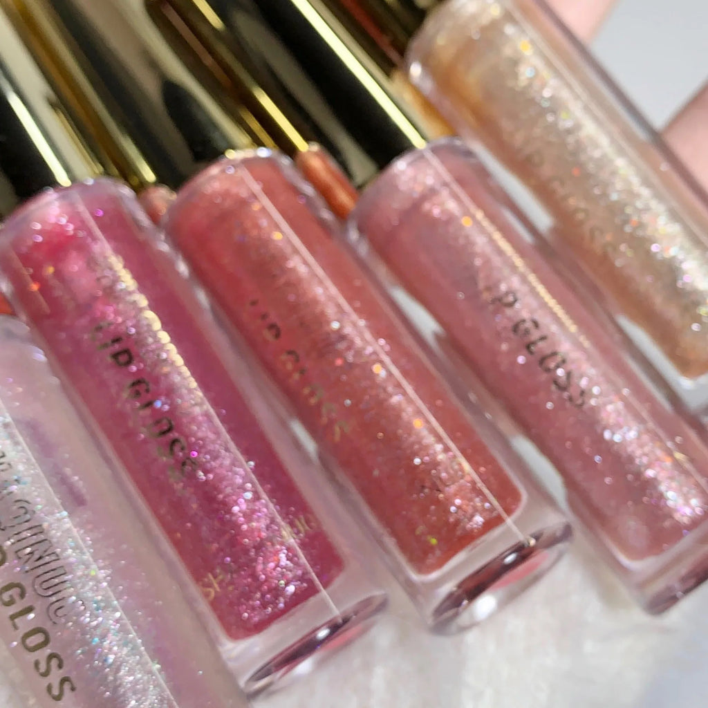 Moisturising flash lip gloss with mirror finish in five colours: cherry blossom pink, gilded flash, peach, purple, and berry red.