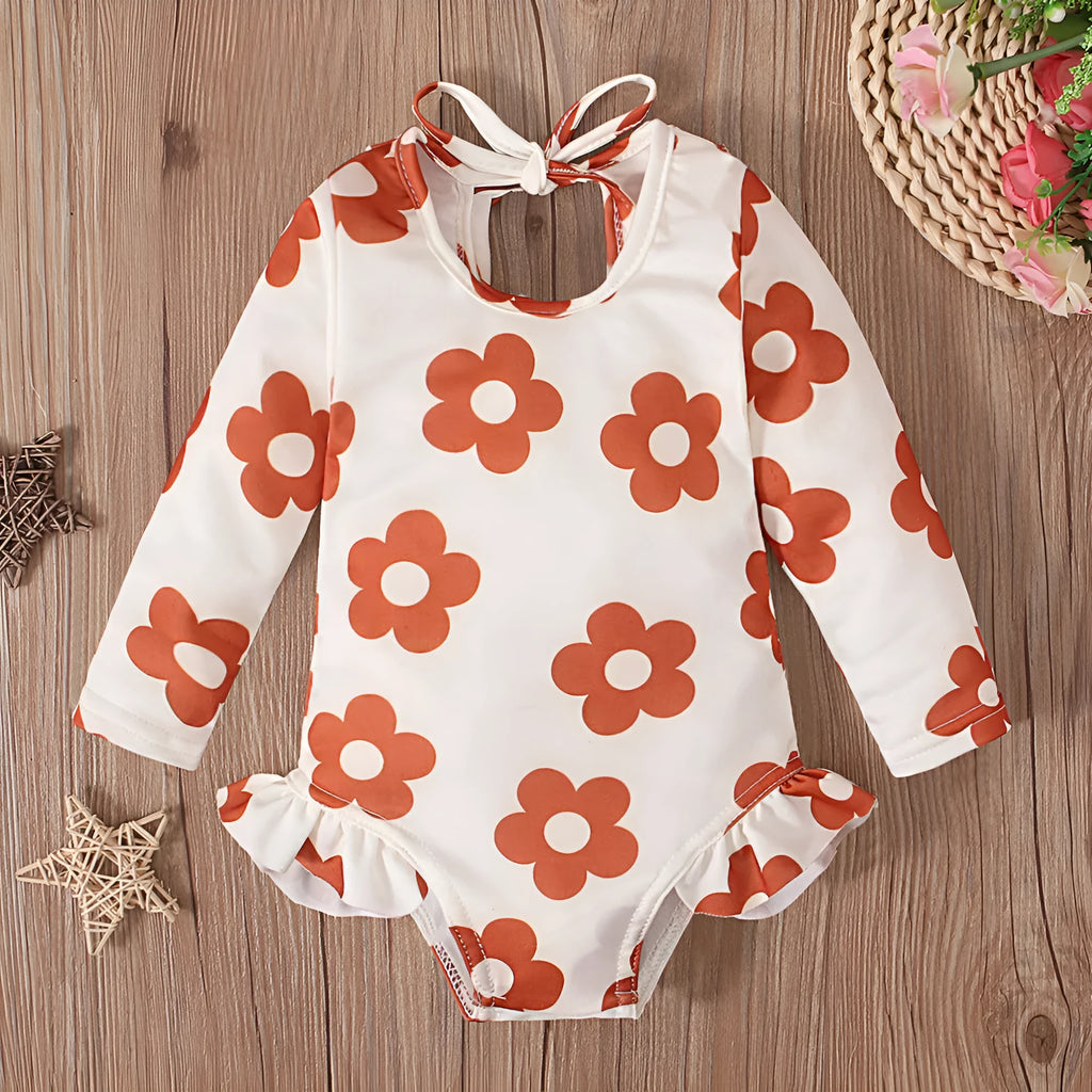 Girl's floral print swimsuit with crew neck and open back in orange red colour.