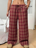 Women's loose plaid trousers with drawstring waist and side pockets in red or blue colour options