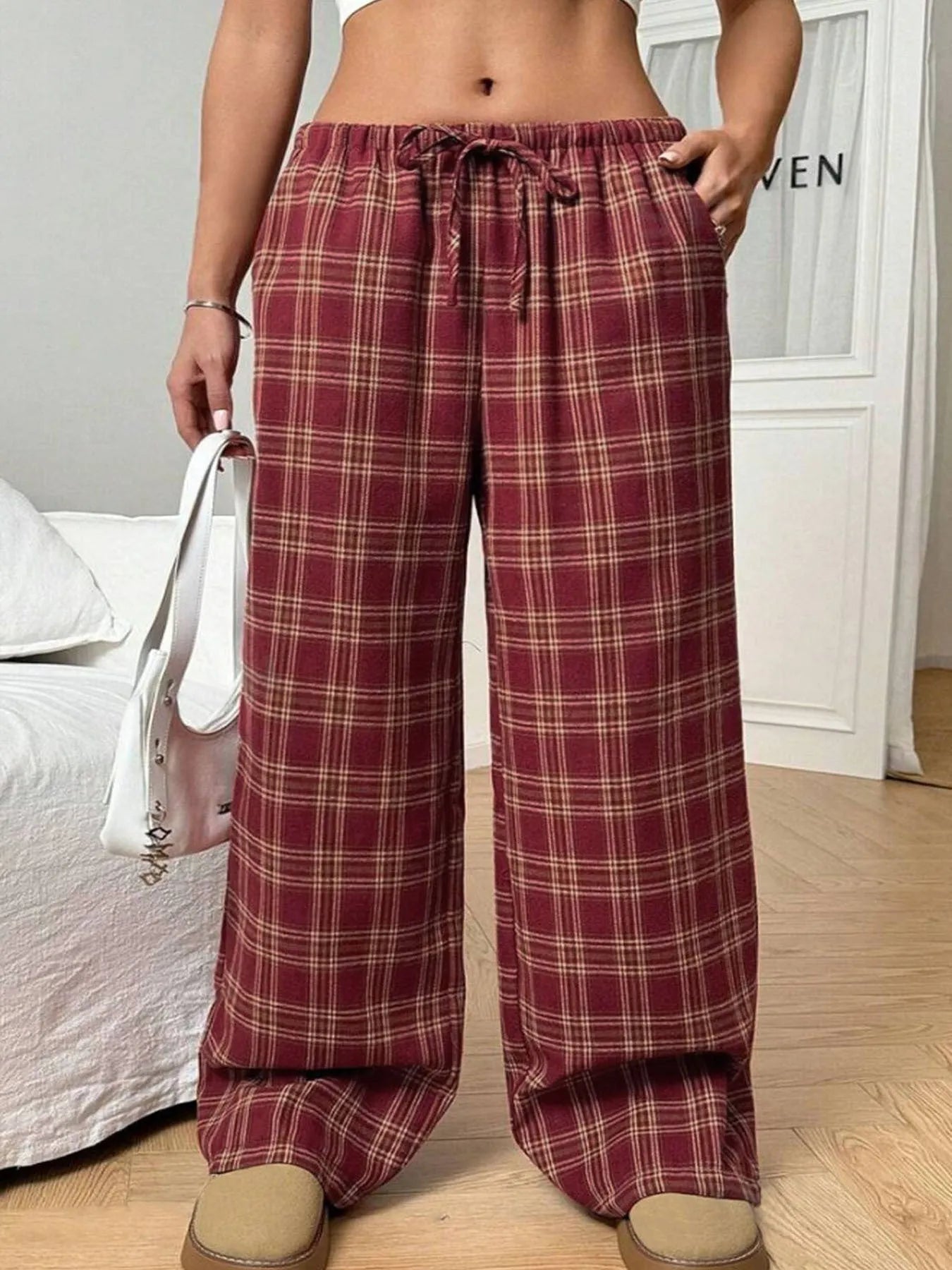 Women's loose plaid trousers with drawstring waist and side pockets in red or blue colour options