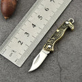 Brass mini folding knife keychain pendant with 3cm blade and 42mm shank on a key ring