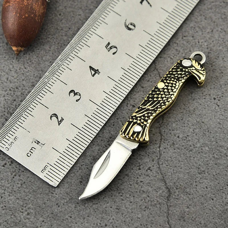 Brass mini folding knife keychain pendant with 3cm blade and 42mm shank on a key ring