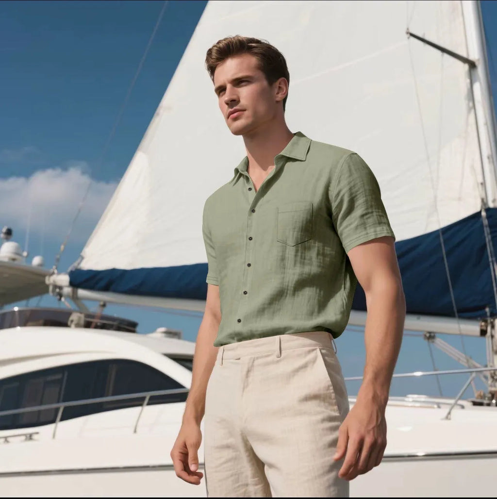 Man wearing a loose-fit light blue linen short-sleeved shirt in a casual setting.