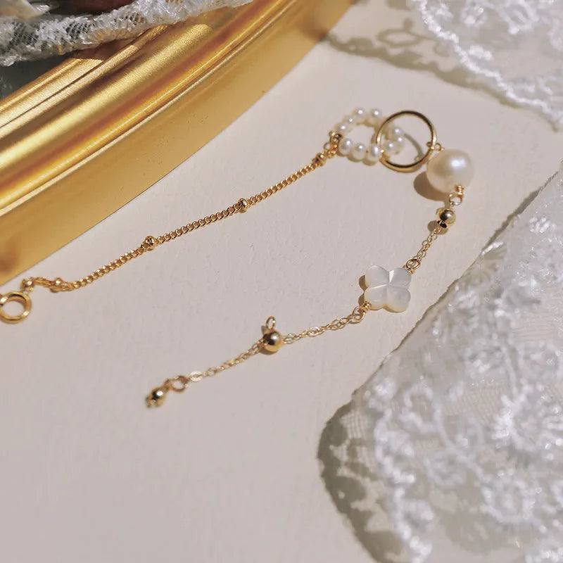 Women's natural pearl bracelet with 14k gold-plated setting.
