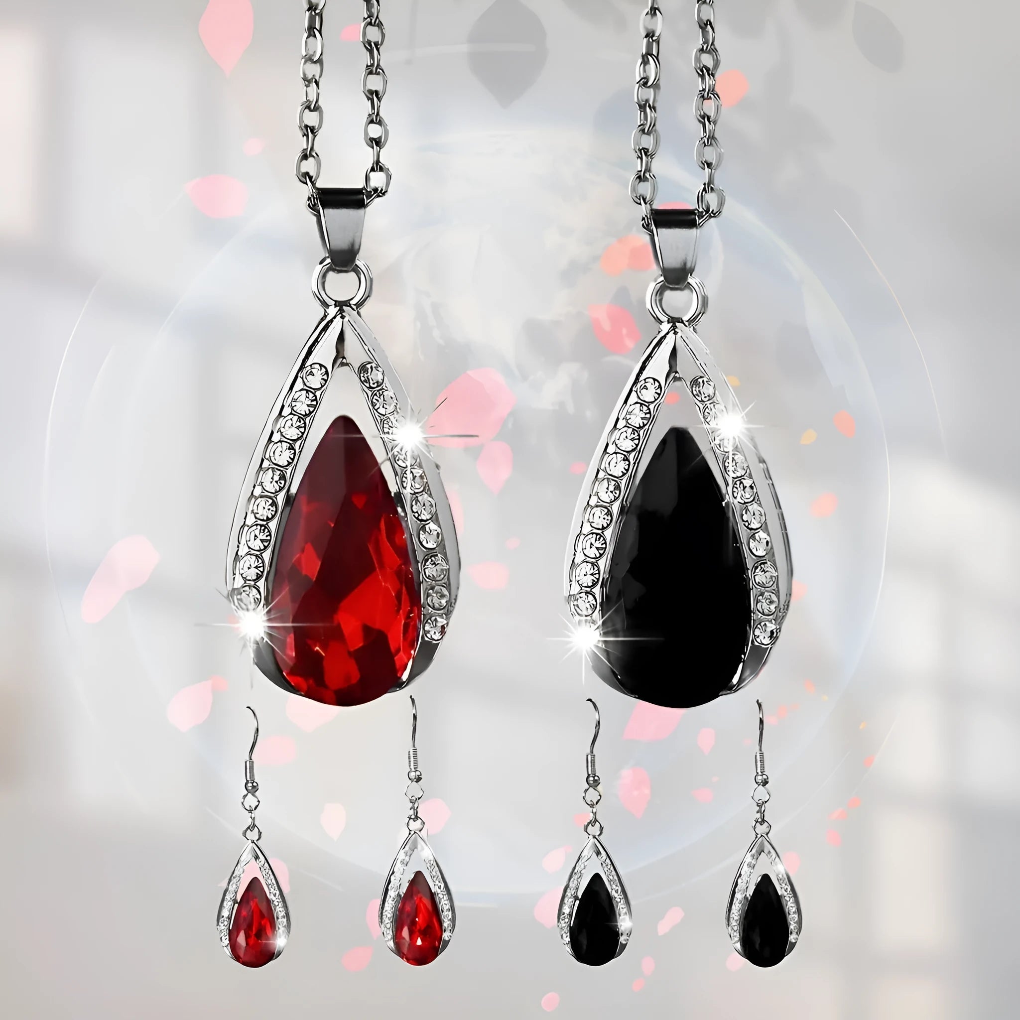 Black and red teardrop glass pendant necklace and matching earrings set on a white background.
