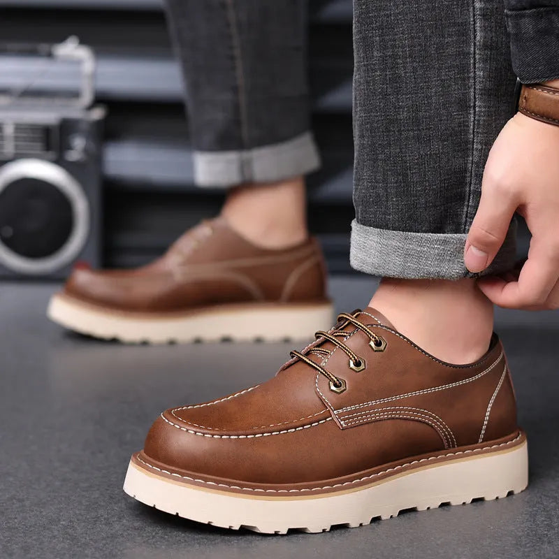 A pair of men's black retro-style low-top casual boots with a round toe and a rubber sole.