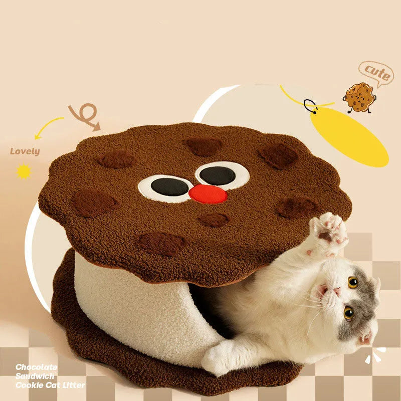 Khaki coloured enclosed cat nest shaped like a sandwich cookie with a circular entry hole.